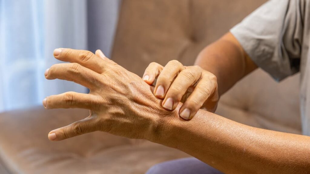 Person stretching stiff joints in the morning due to reduced mobility and joint discomfort